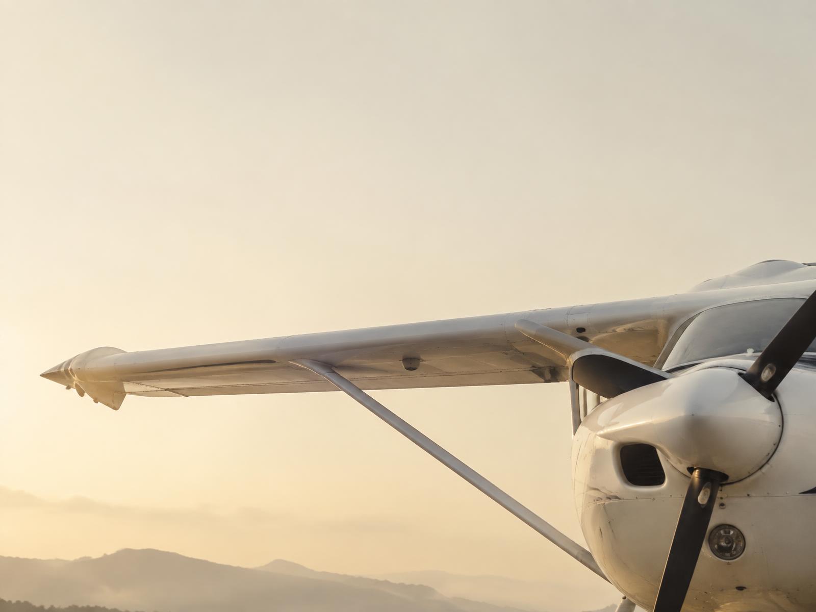 Training aircraft wing at sunrise